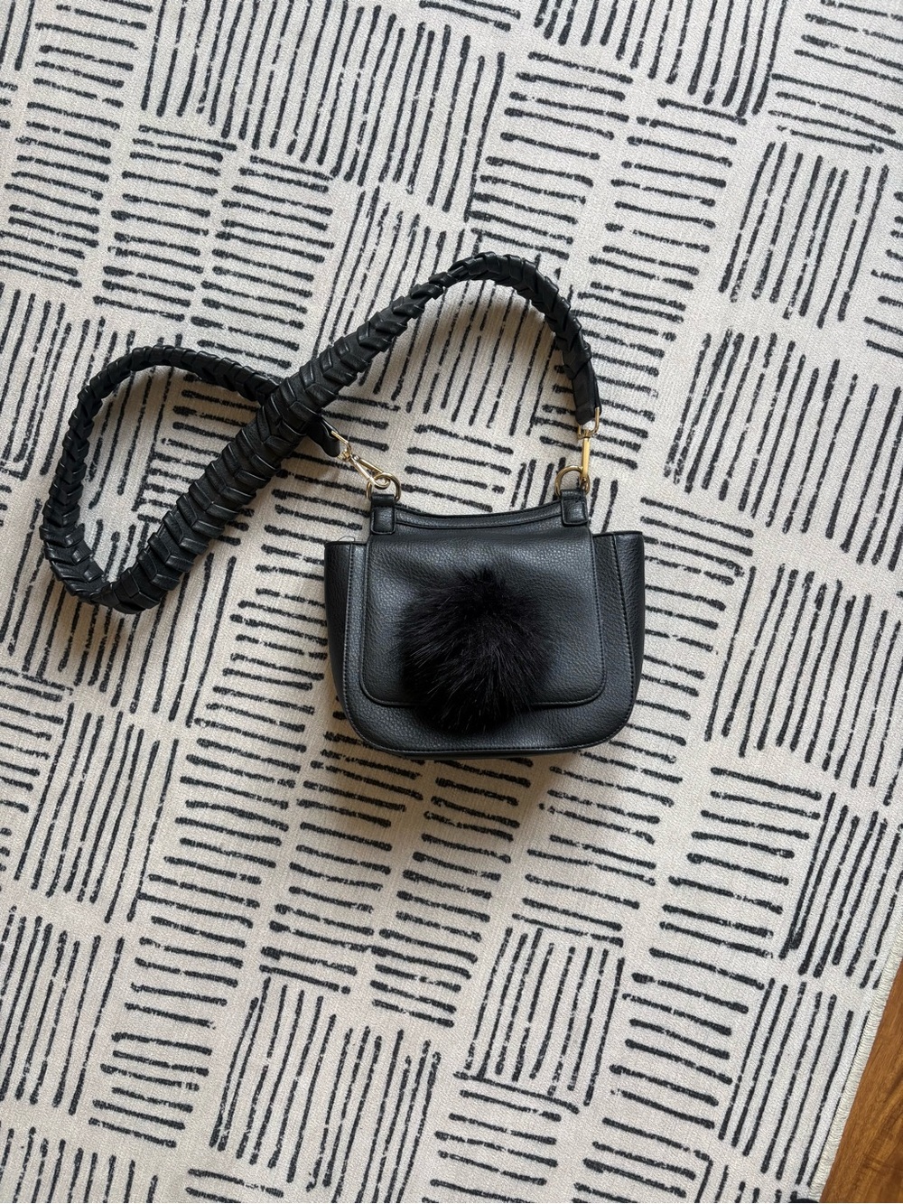 Compact Black Crossbody Bag with Braided Strap and Pom Pom